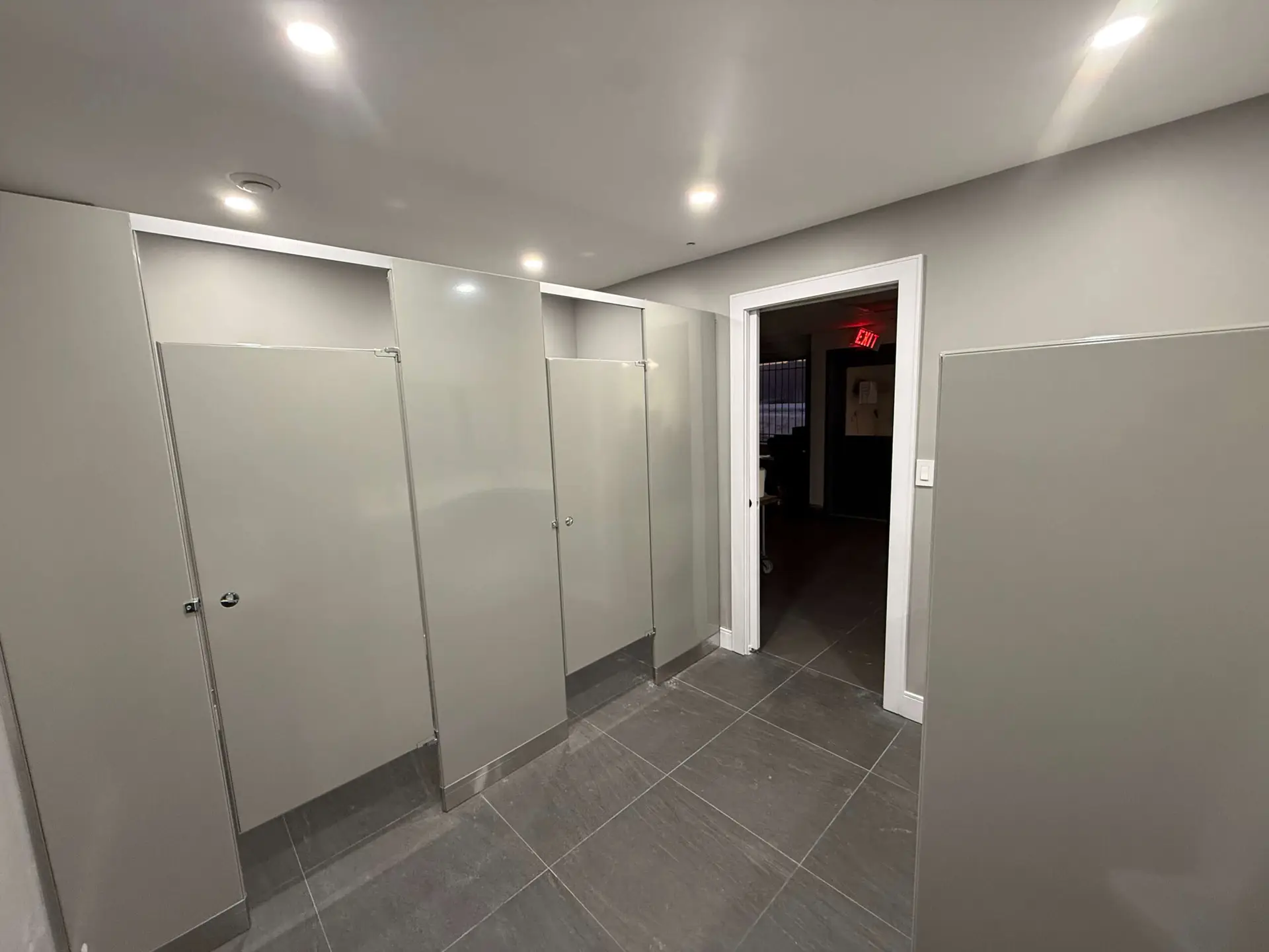 Commercial washroom with partitions by Kodiak Construction Group