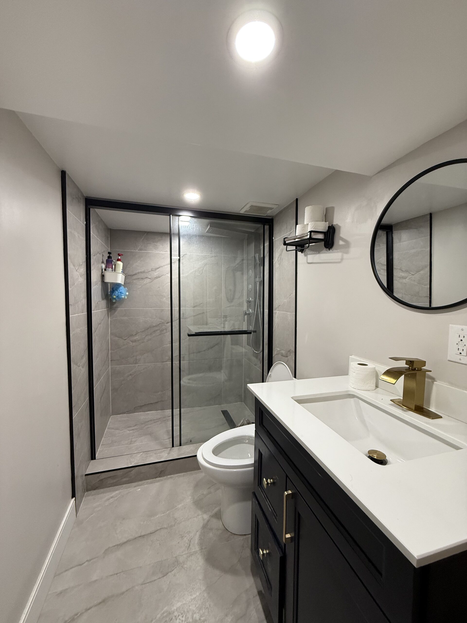 Home Bathroom renovation with glass shower by Kodiak Construction Group