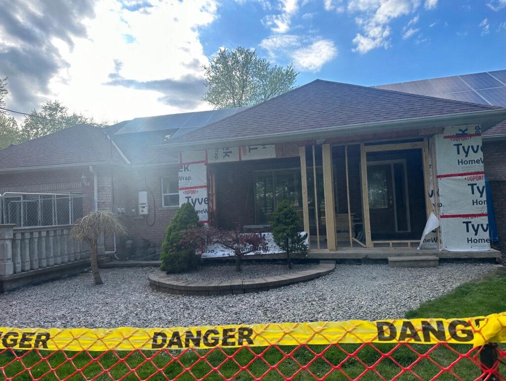 House exterior wrapped in weather barrier during a home addition project