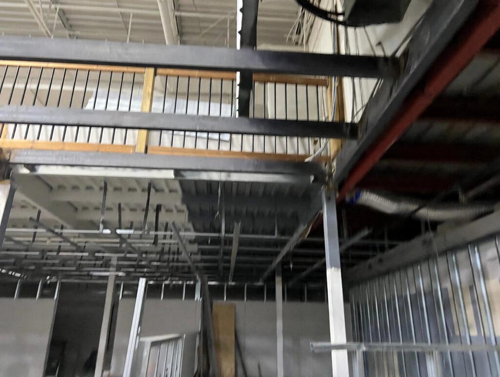 Steel mezzanine structure with railings during a commercial build-out