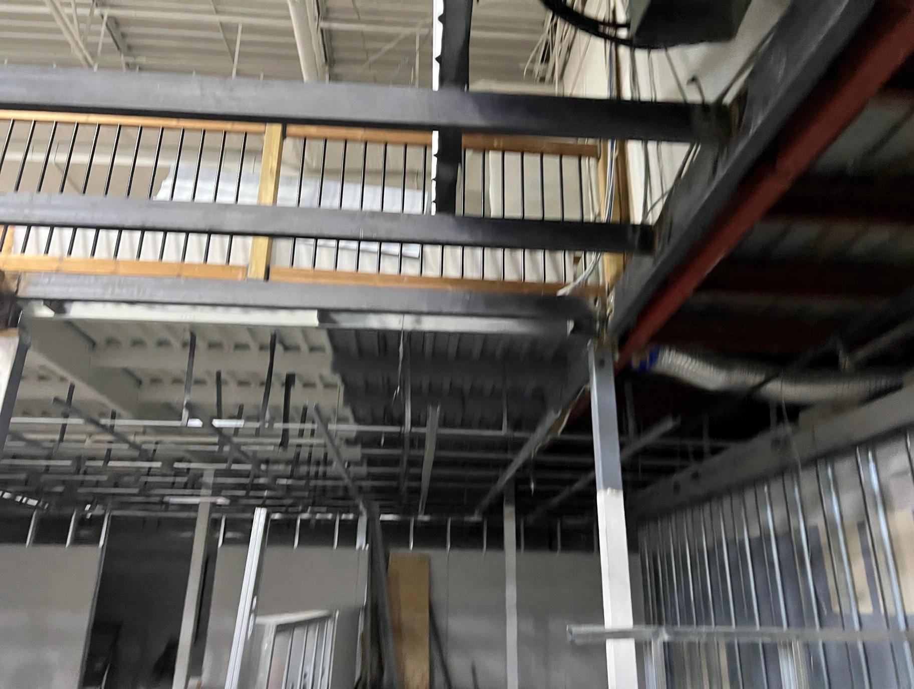 Home Steel mezzanine structure with railings during a commercial build-out