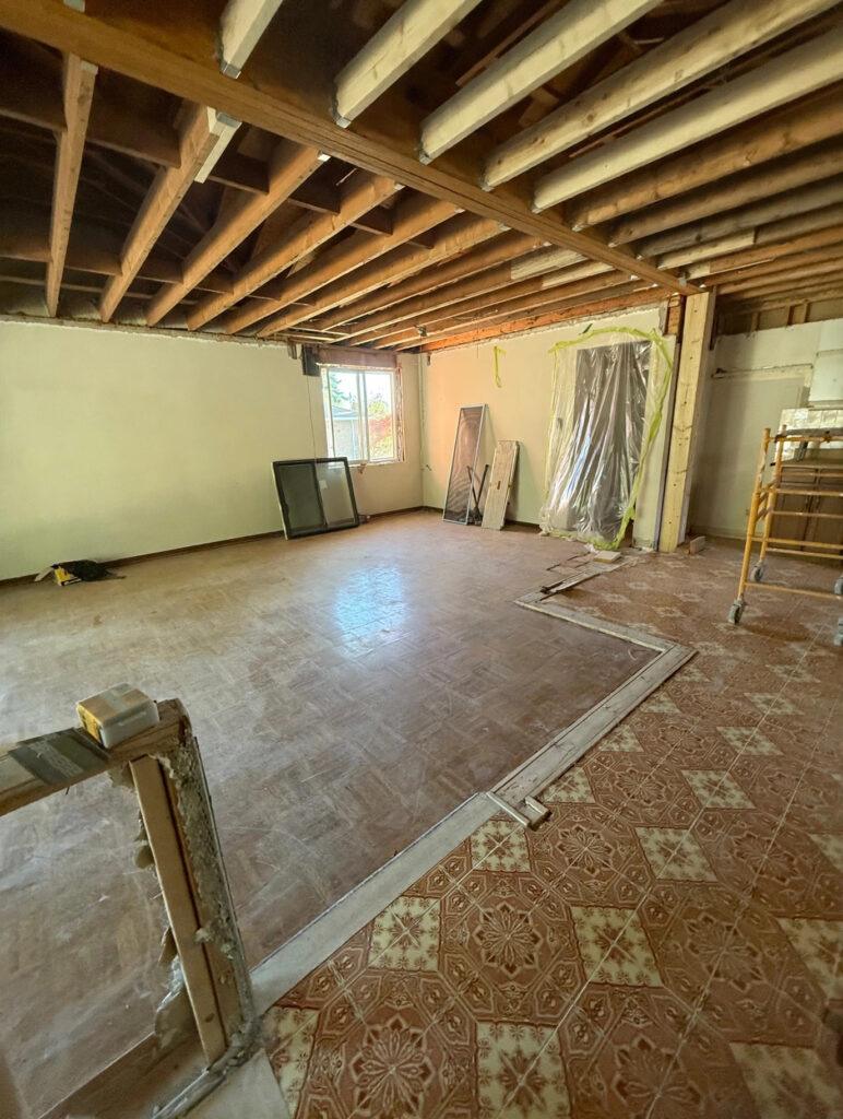 Exposed ceiling joists during a load-bearing wall removal in a home