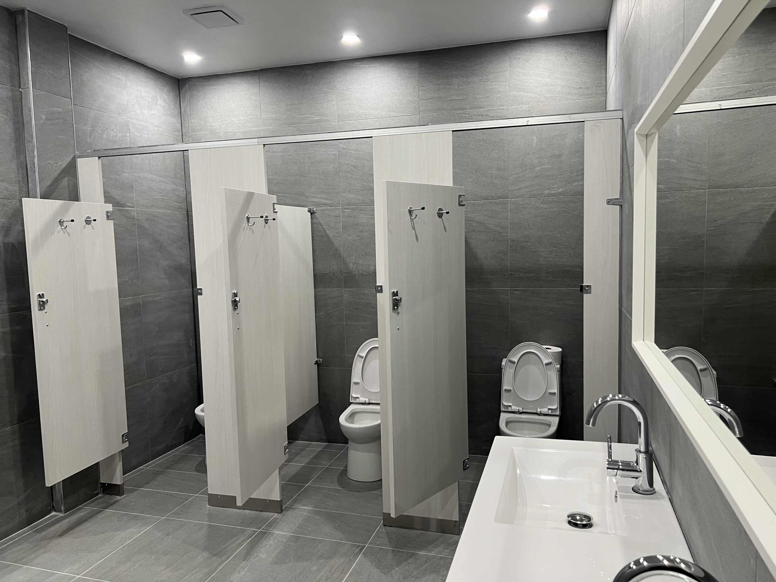 Home Commercial washroom toilet partitions by Kodiak Construction Group